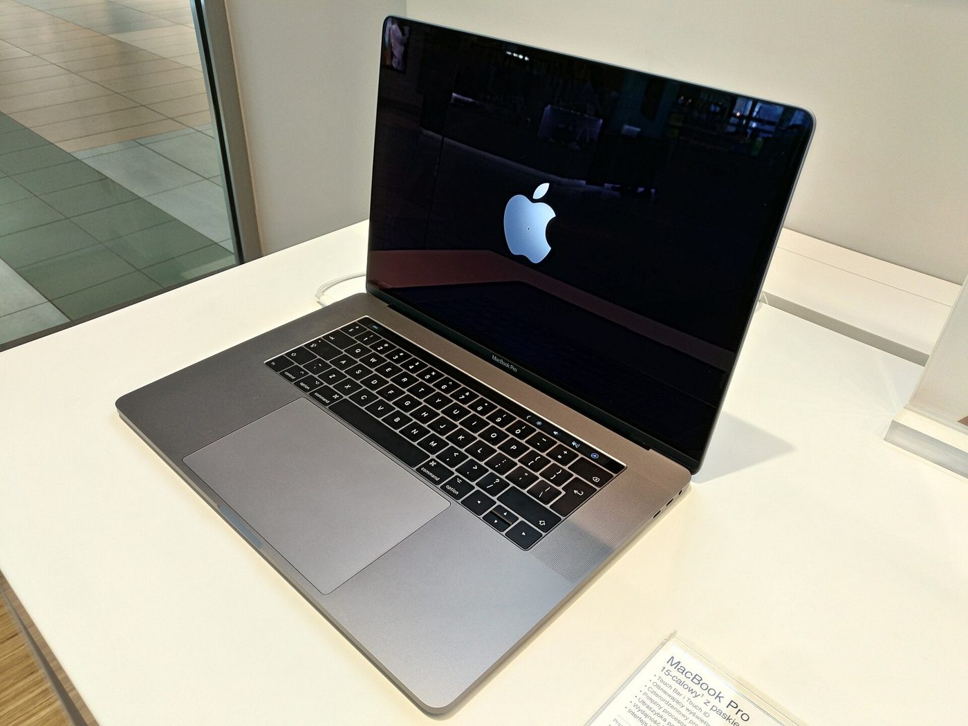 A 15-inch 2017 MacBook Pro with Touch Bar on display in a store