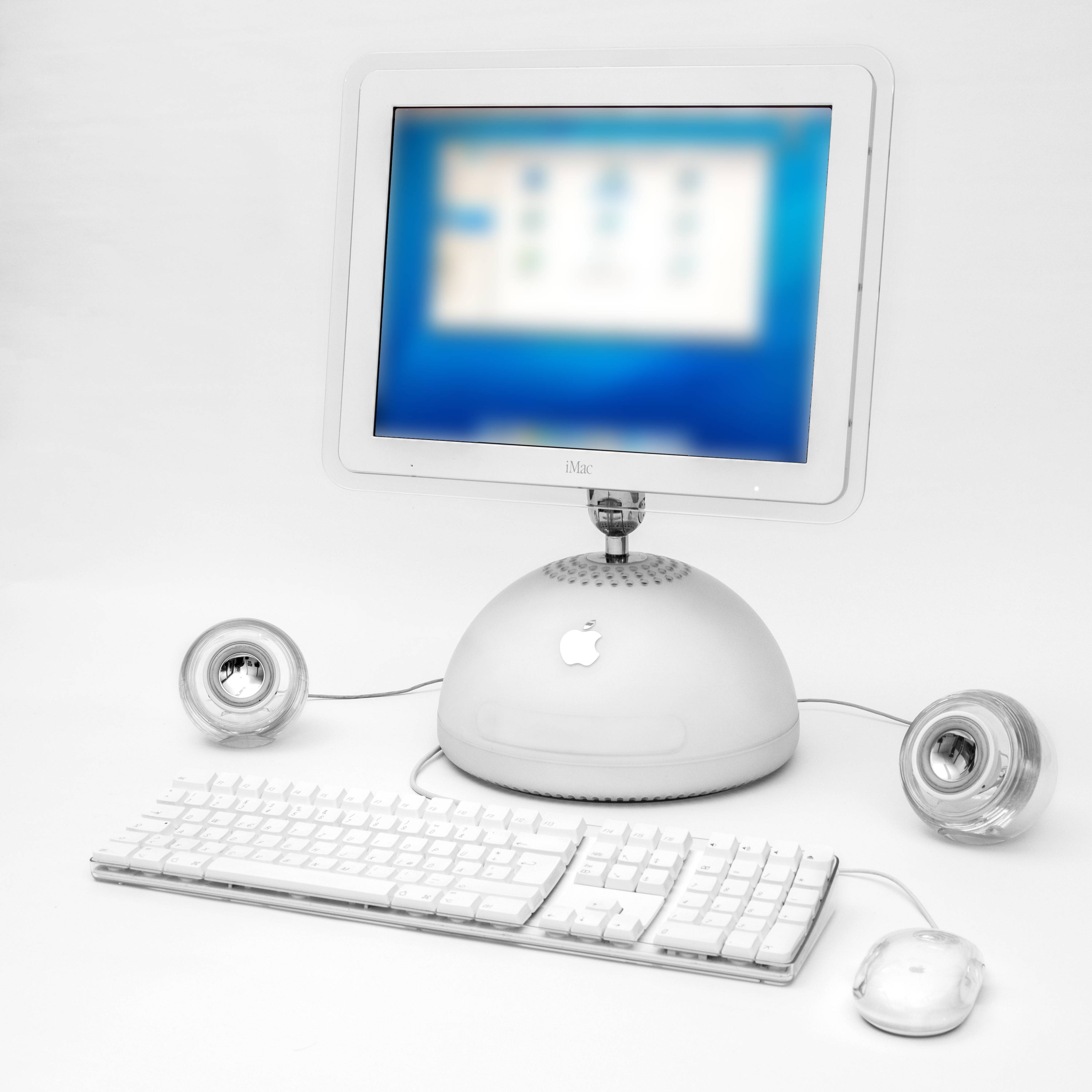 Apple iMac G4 with its screen raised above a round base
