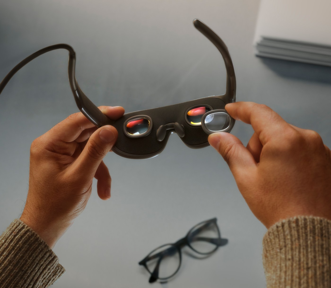 A person holding Meta VR Glasses to show the lenses and inner frame