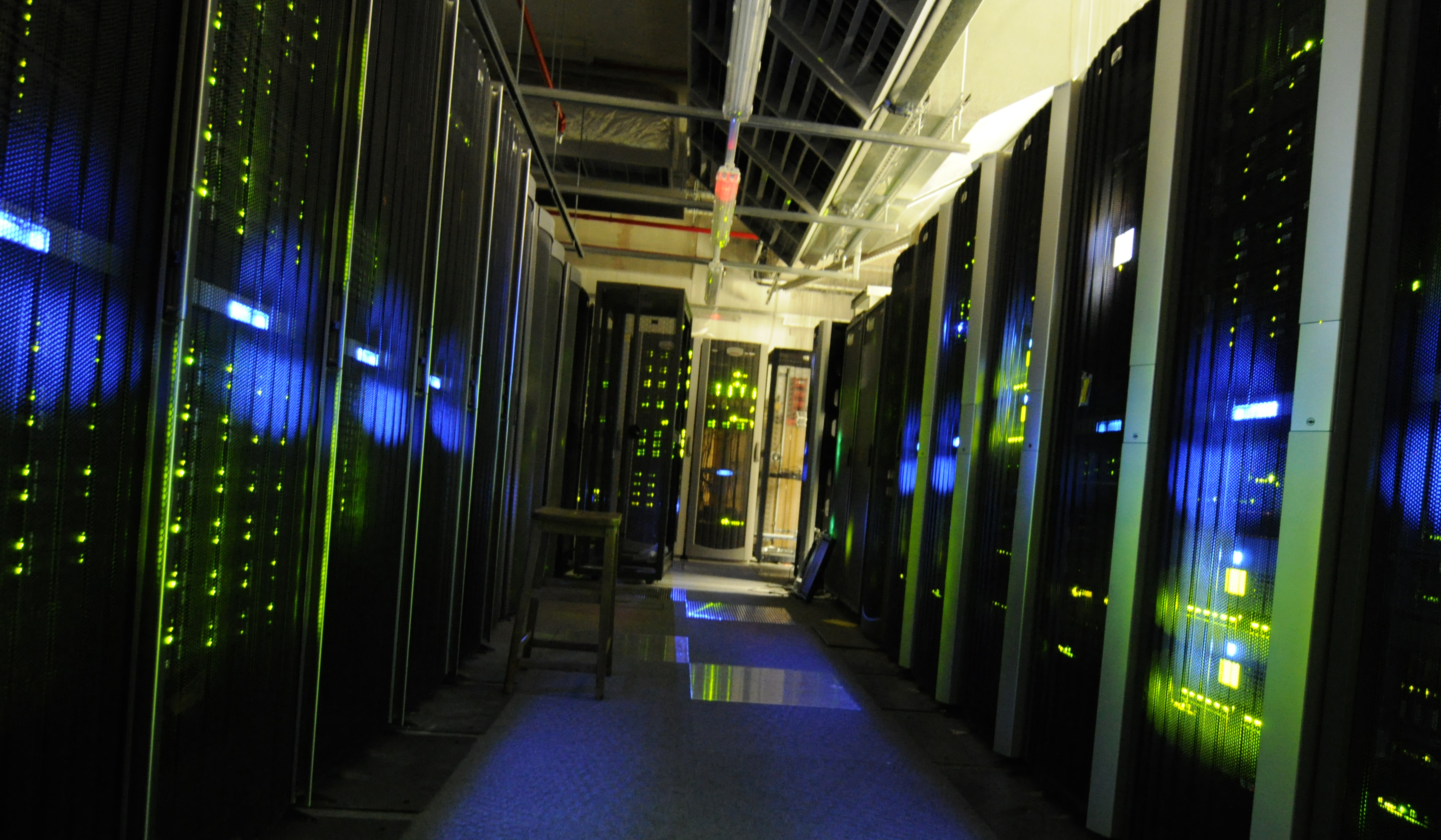 Rows of illuminated servers in a data center