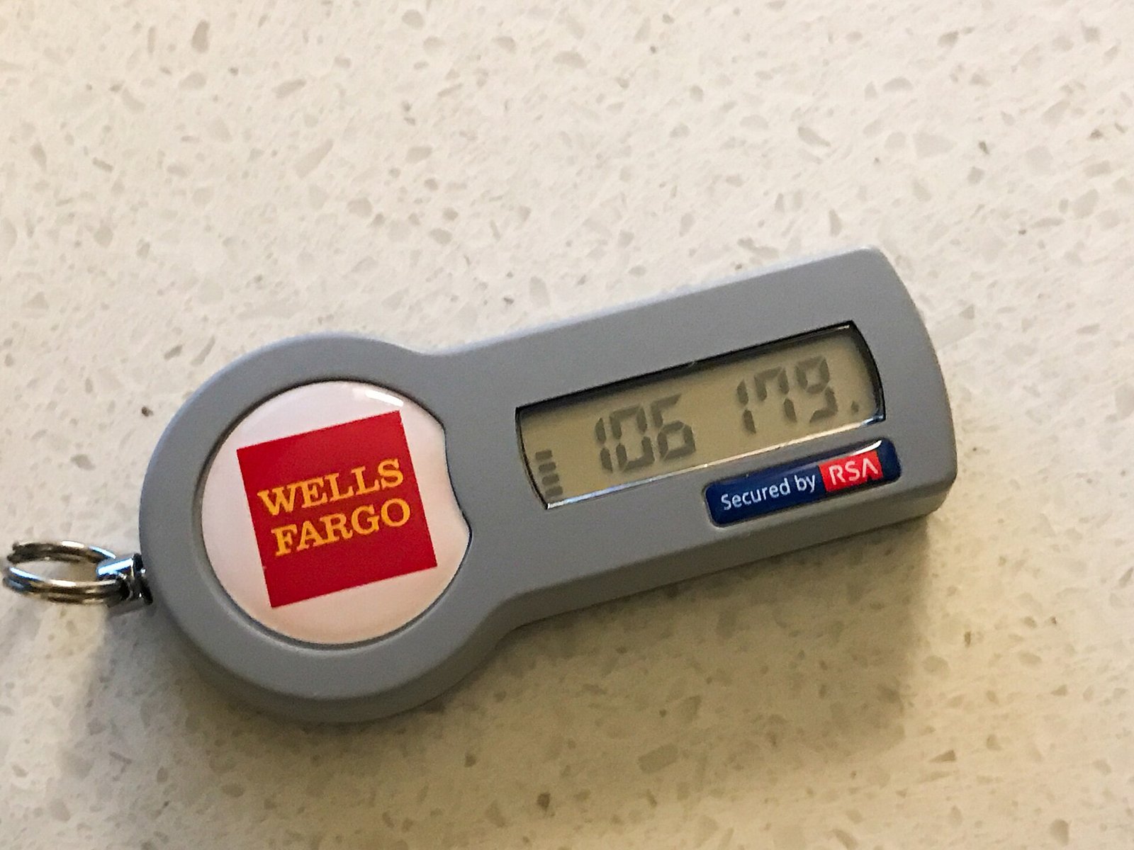 A hardware security token displaying a six-digit two-factor authentication code